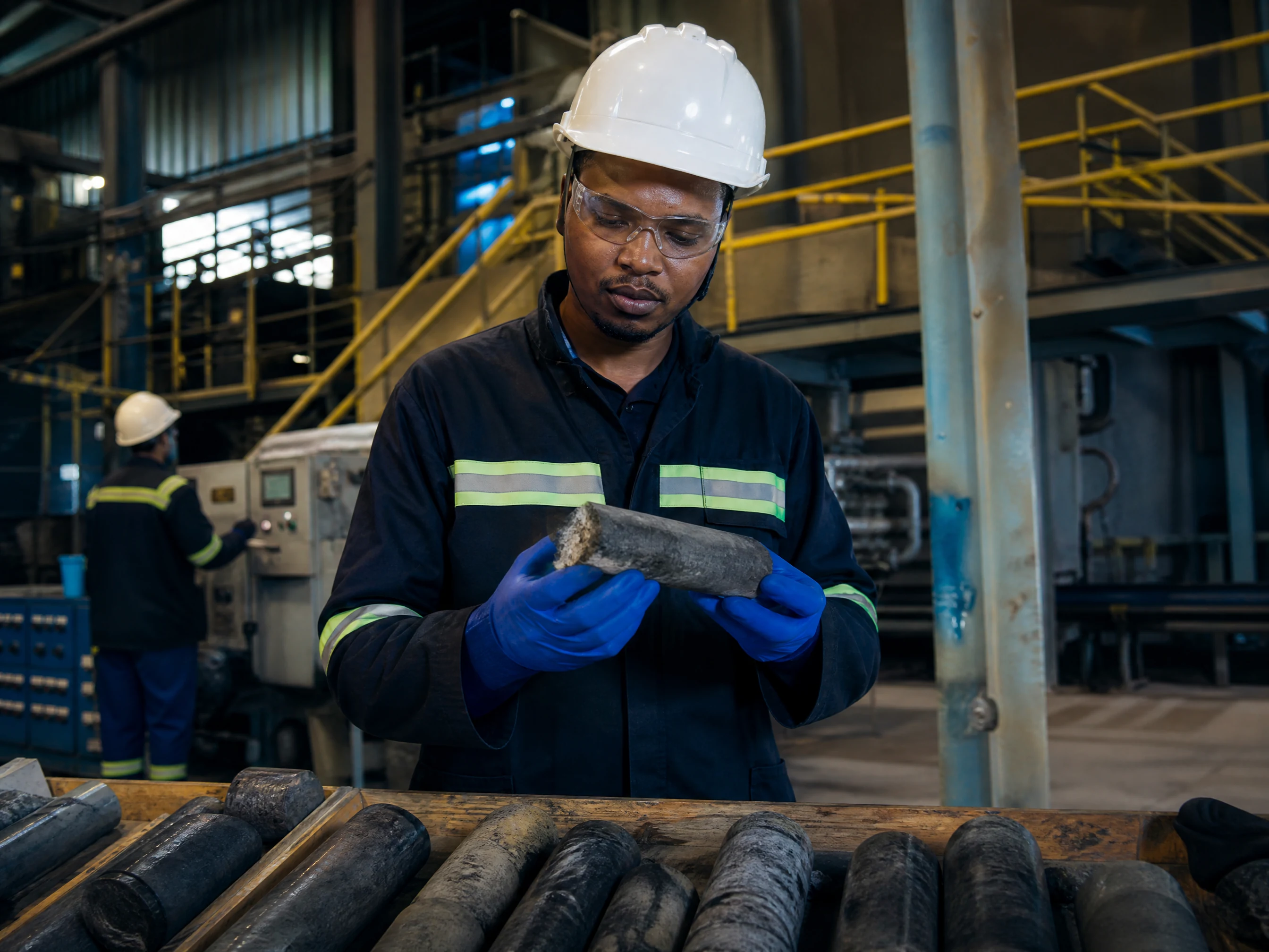 Engineer examining process samples and technical data in a metallurgical facility
